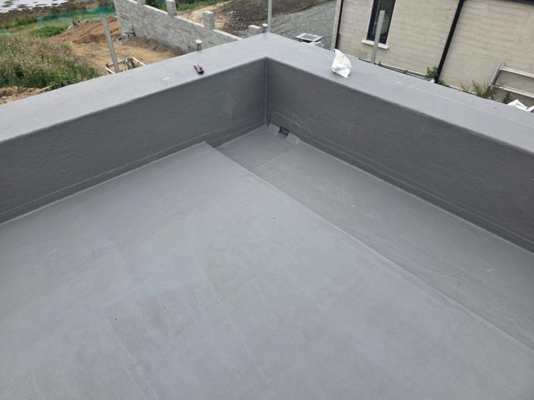 The drainage channel sits at the roof's far end, so that water is carried away from the building itself