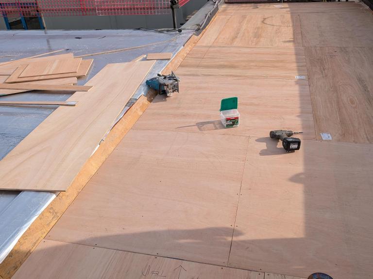 Plywood boarding, providing a reinforced substrate for the roof and boxing in insulation