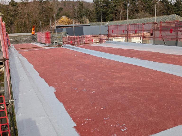 The stripped back roofing area in the process of being waterproofed