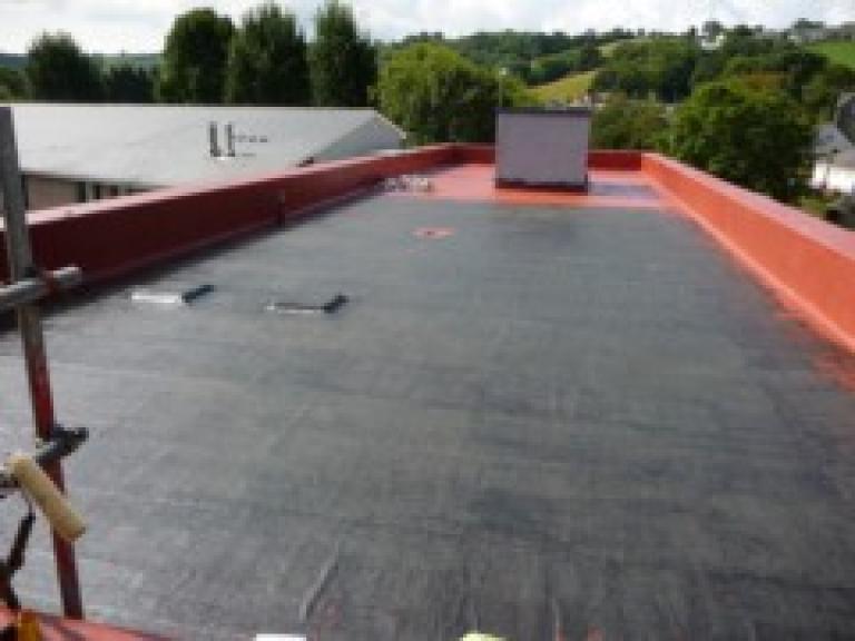 After pressure washing and priming, the coating process was begun...