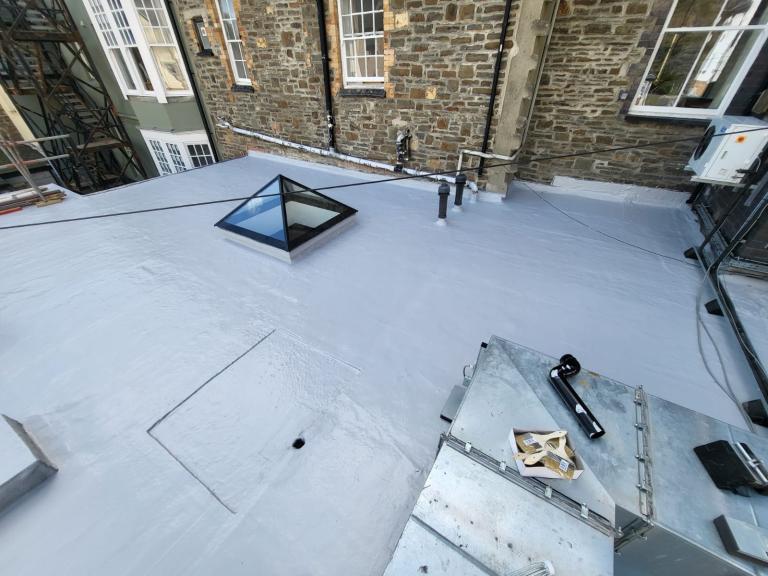 The polymer system is applied to upstands to ensure full waterproofing