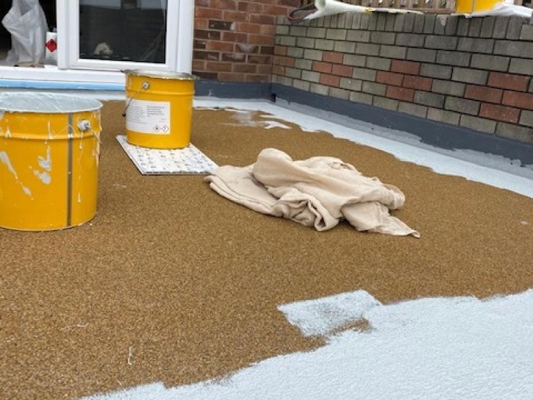 Overcoating it to seal the area