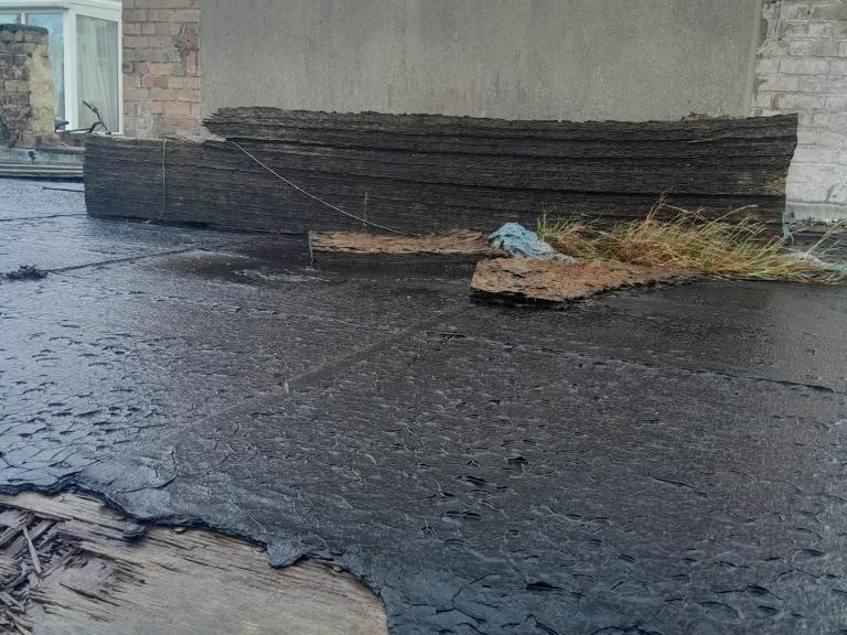 First view - the garage roof was peeling, cracked, fragmented and rotting