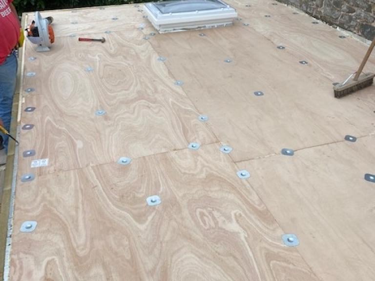 The plywood layer is bolted down