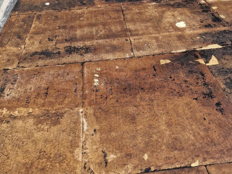 Large patches of damp showed where water was sitting