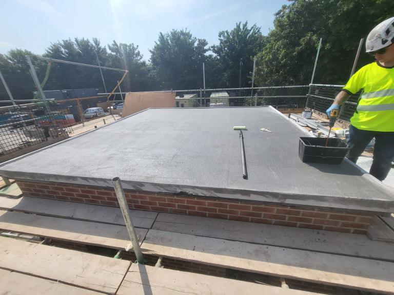 The roof is lipped on three sides and open on one for drainage