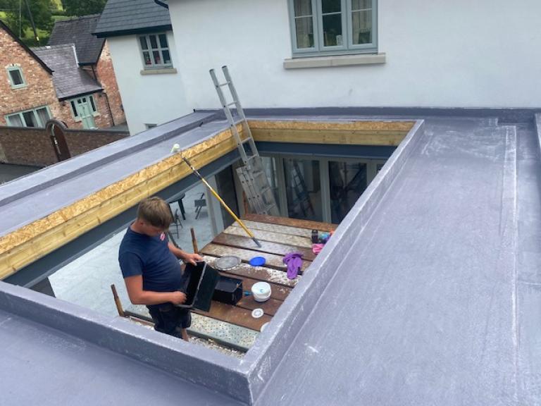 The roof edge channels rainwater to the side channels