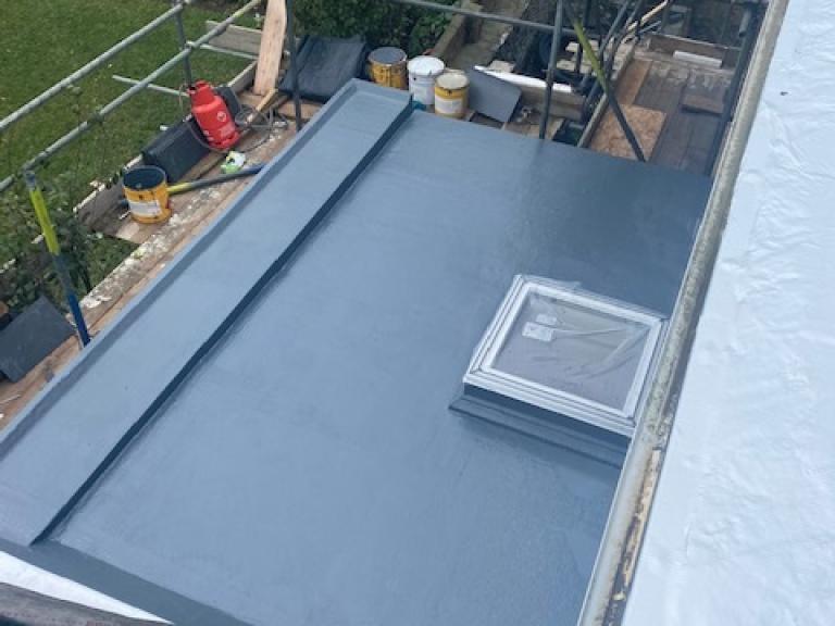 The smaller flat roof with skylight and tapered rainwater system