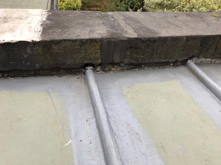 First sections of undercoat being applied next to existing leadwork