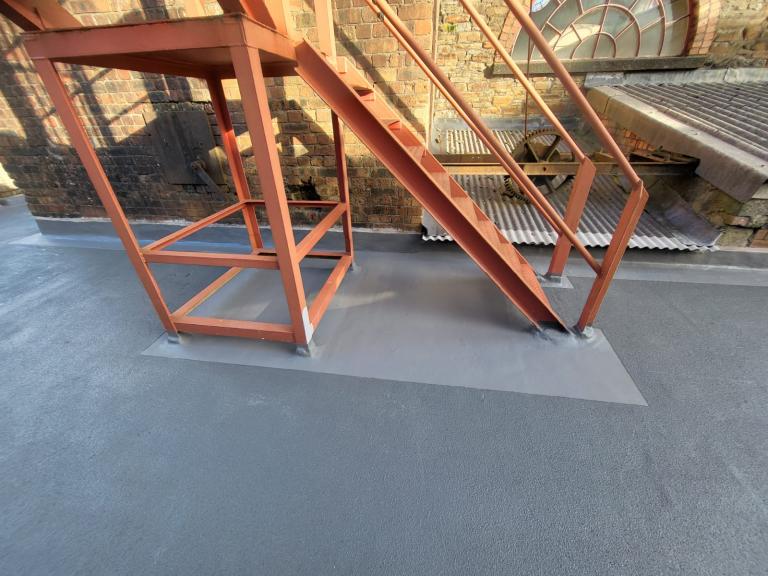 The same perfect-forming seal is crucial at hte base of metal structures. These feet are now thoroughly protected.