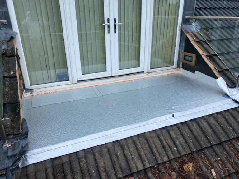 We then began installing the underlayer to protect the wood substrate