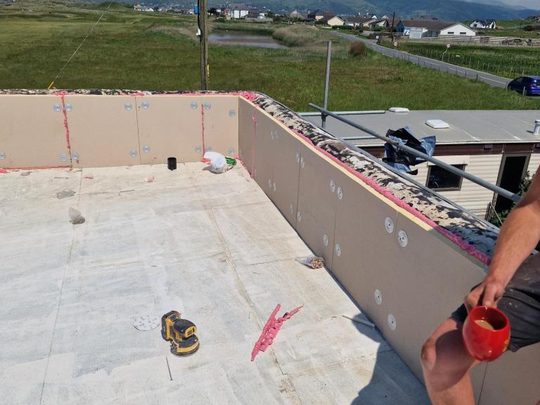 The sun drying the undercoat. Note the insulation on the parapet walls