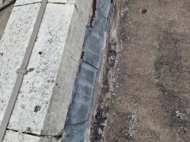 There was significant degradation along parapet bases