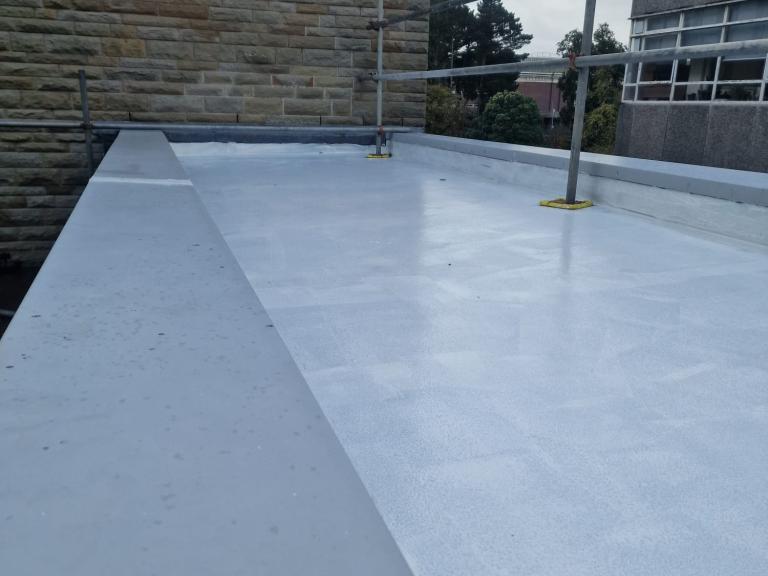 The waterproofing extends up the parapets to prevent water ingress at edges