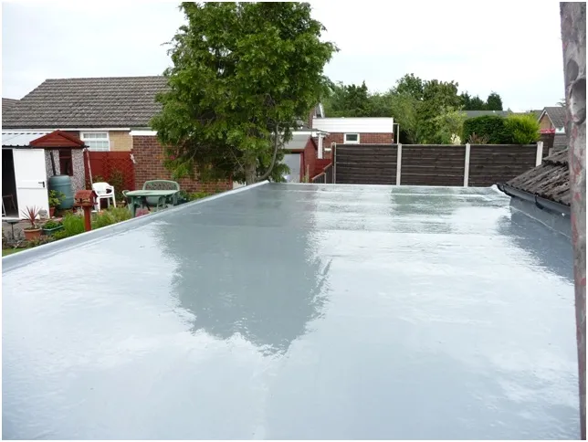 UV top coat applied to give 15-year garage flat roofing system