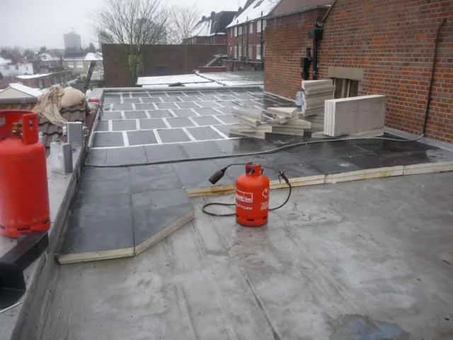The tapered warm roof insulation being laid