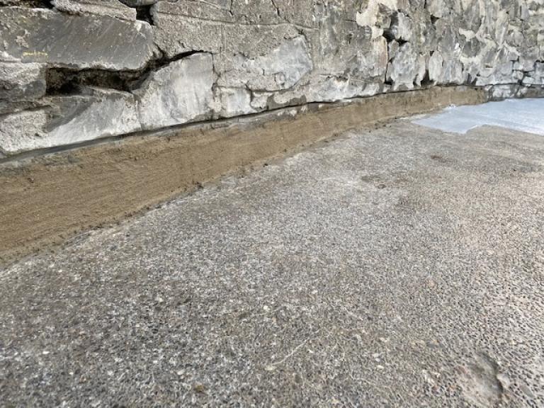 Pressure cleaning revealed lots of mini potholes and surface damage