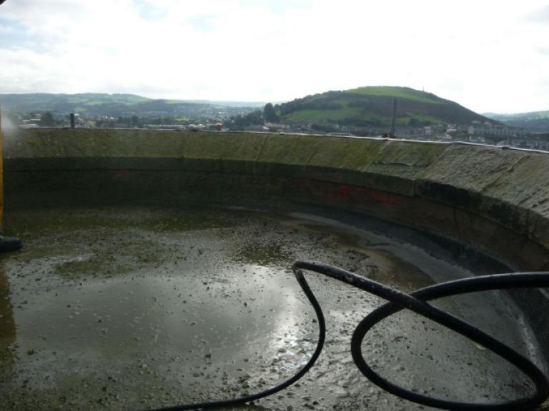 The tower stairwell roof during pressure washing, which shows up exactly what repairs are needed