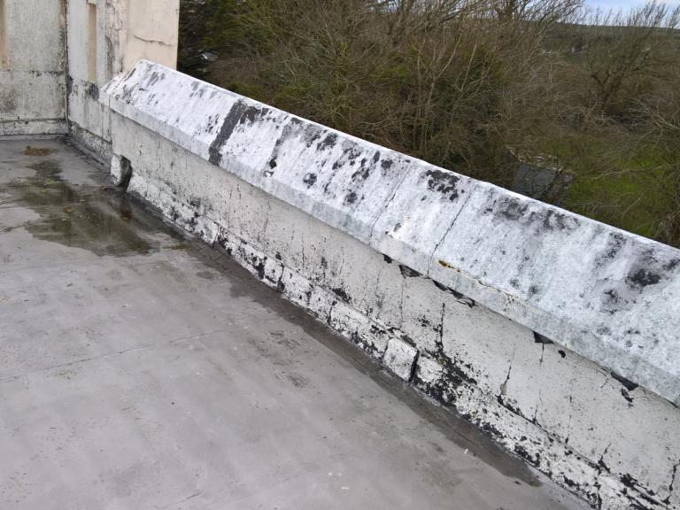 A final view of the cracked and pooling roof before the new system goes on