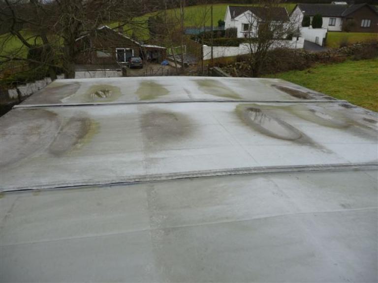 Before - The flat roof was leaking and threatening the integrity of the roof decking