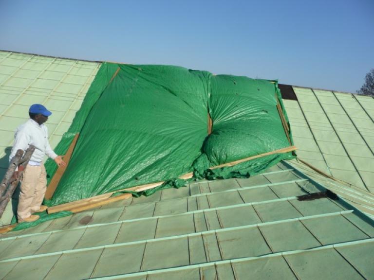 Work begins on this vandalised London church roof...