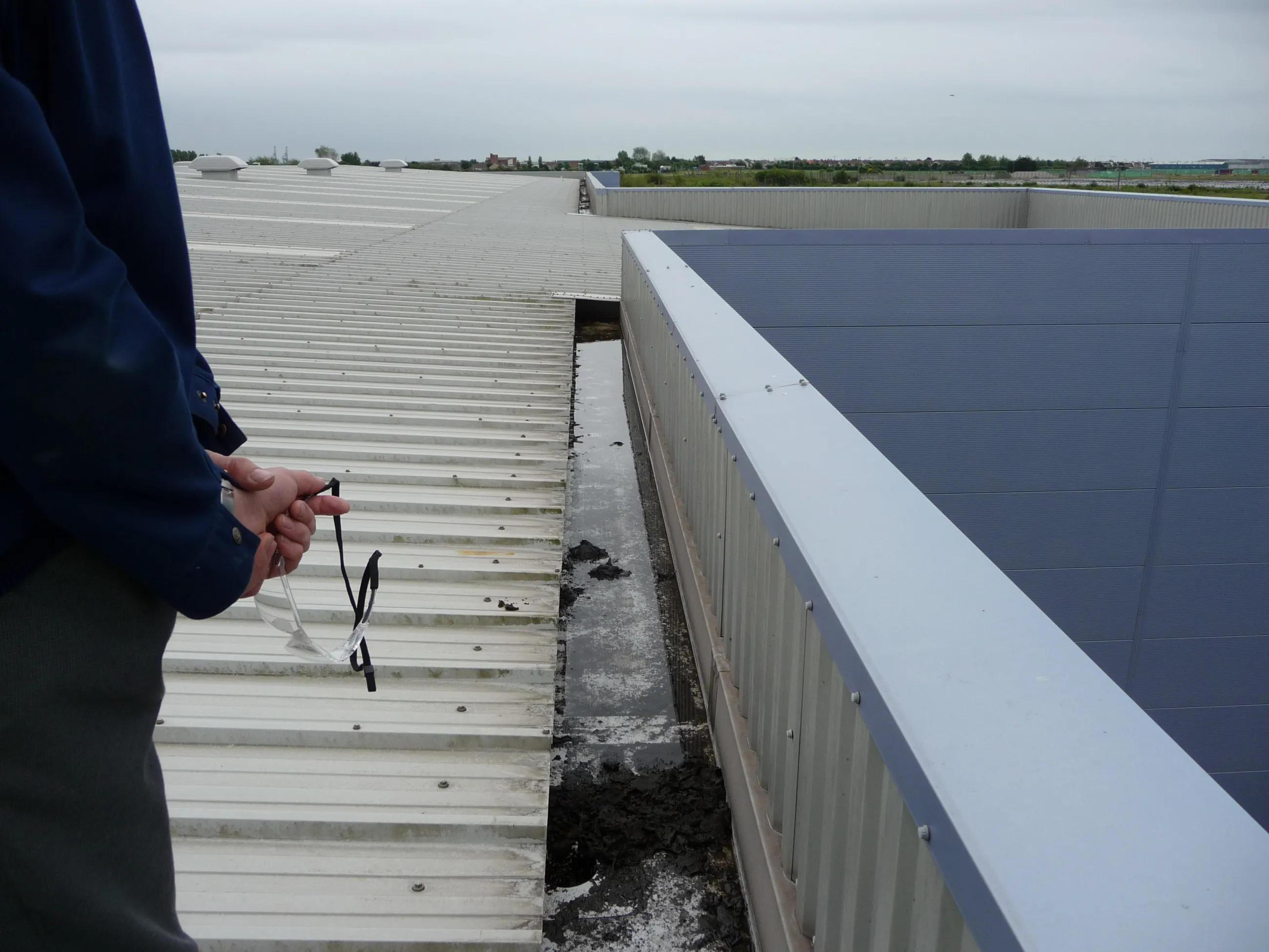 Leaking factory metal box gutter at Bagland Industrial Estate, Port Talbot, for a prestigious car manufacturer