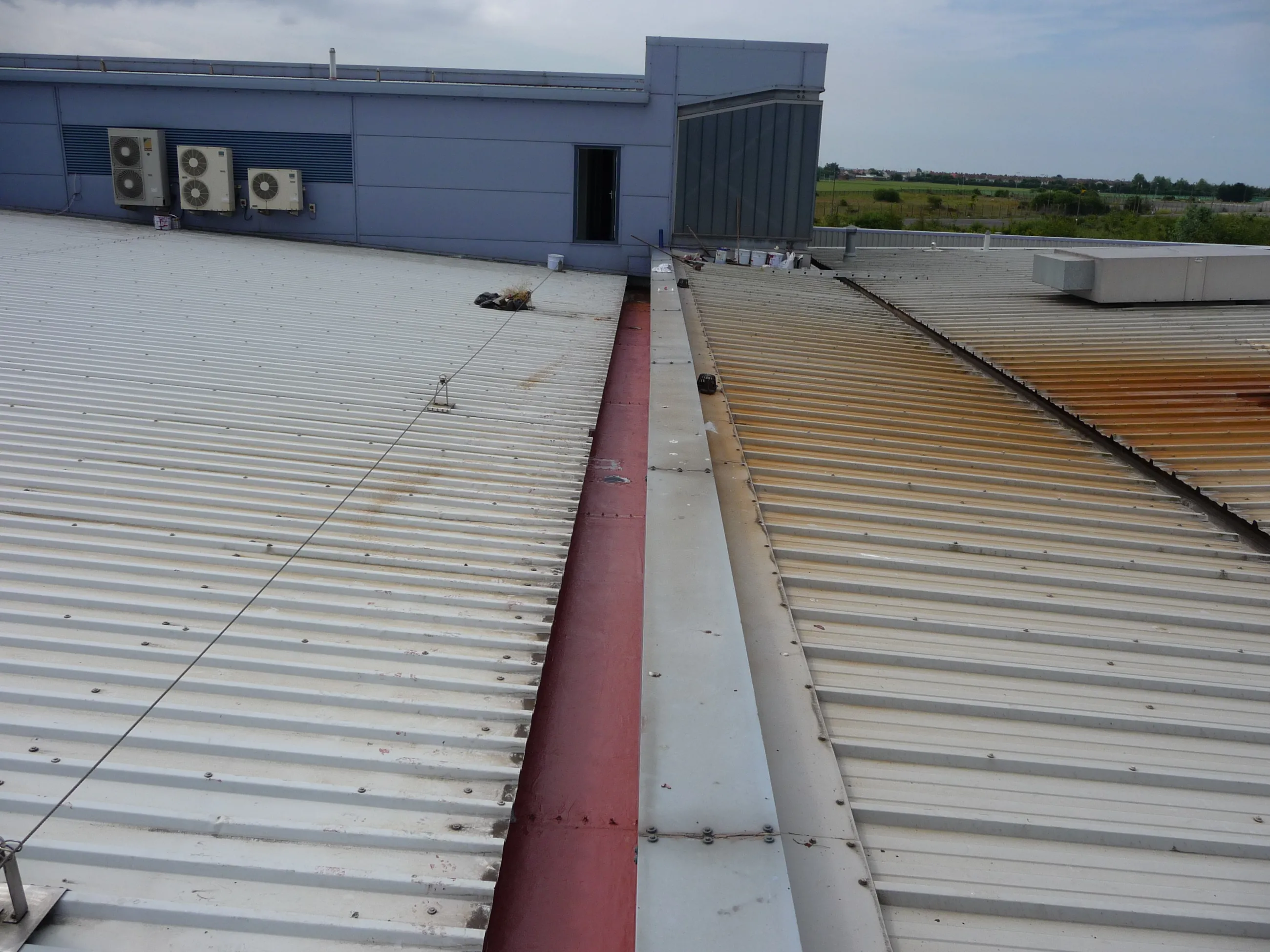 leaking factory roof  metal  gutter 1st coat applied